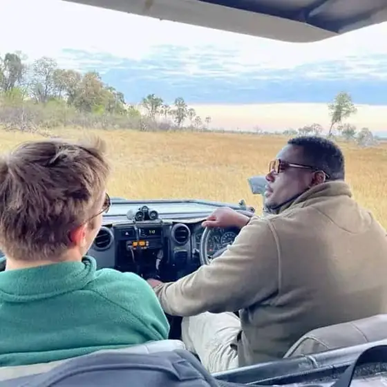 Guide and guest talking on a morning game drive