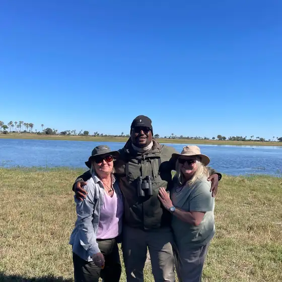 Guests with their guide beside an Okavango lagoon