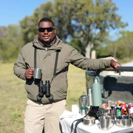 Guide with the sundowner table set up in the bush